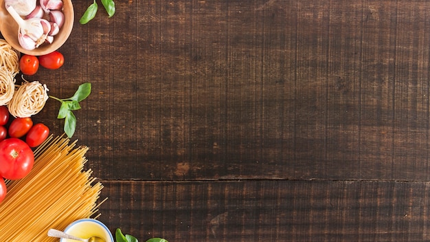 Ingredients for cooking pasta on wooden background