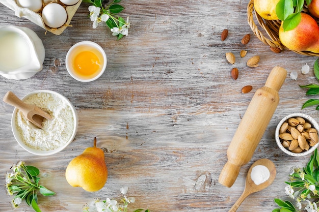 Free Photo ingredients for making buns or pies with jam and fresh pears on a wooden background top view copy space