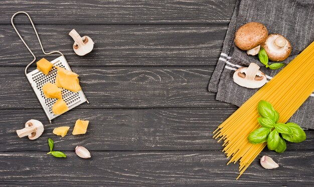 Ingredients for spaghetti with mushrooms on desk