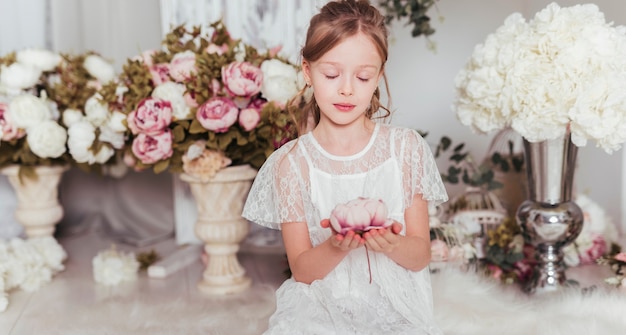 Innocent girl holding flower medium shot