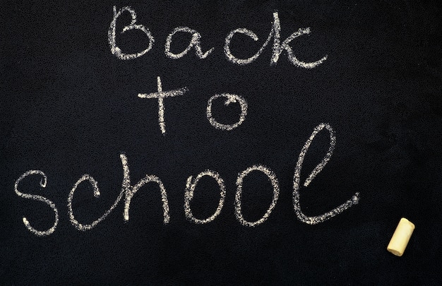 Free photo inscription back to school on black chalkboard, close up.