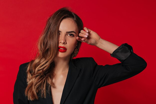 Inside studio portrait of adorable lovely woman with red lips preparing for Valentine's day