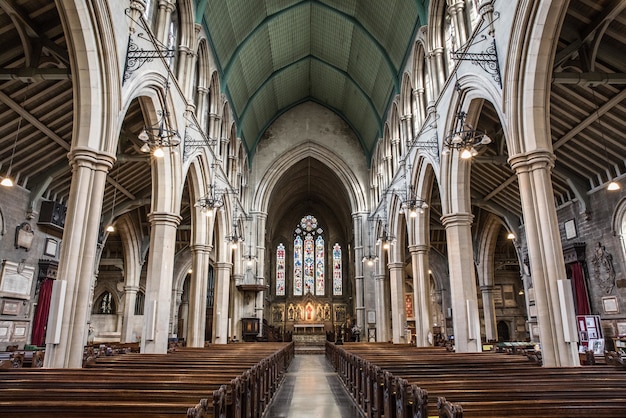 Free photo inside view of a church with religious icons on the windows and stone arches