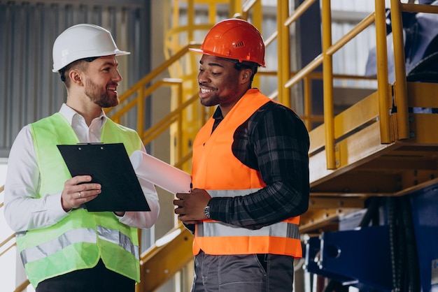 Inspector and african american worker in a factory