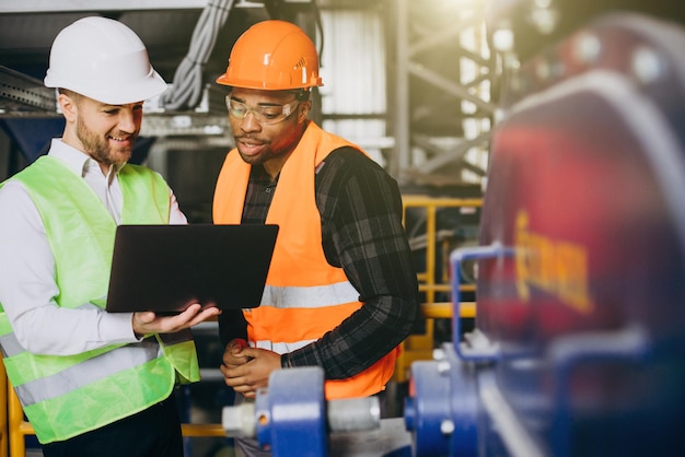 Inspector and african american worker in a factory