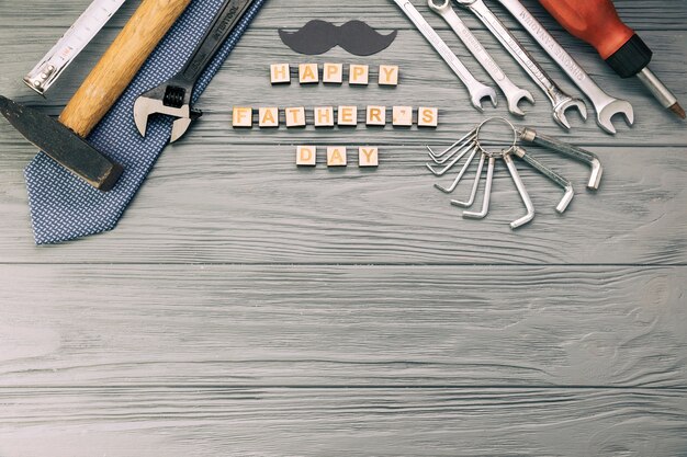 Instruments near decorative moustache with tie and happy fathers day words