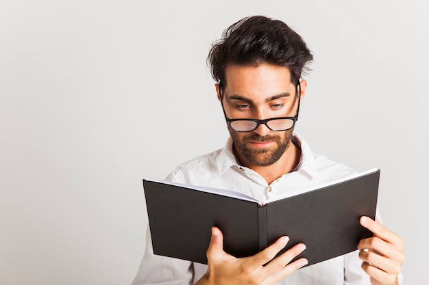 Intellectual man reading with glasses