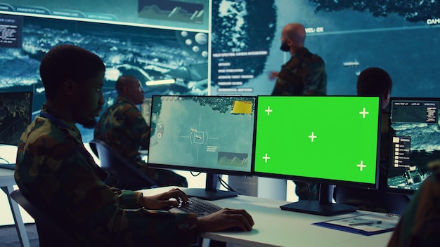 Free Photo intelligence analyst reviews ships activity next to an isolated mockup screen