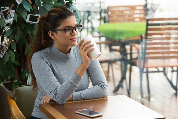 Intelligent businesswoman having coffee break