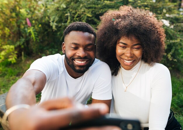 Intercultural friends outdoor taking selfie