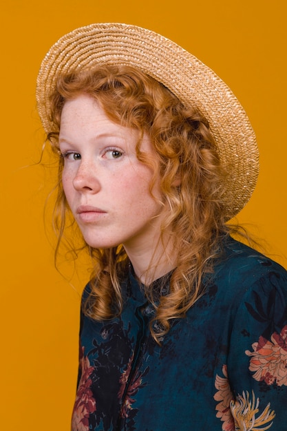 Interested redheaded woman in studio