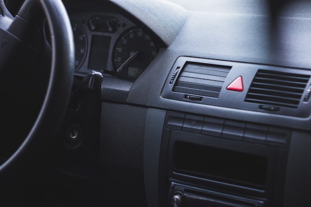 Interior of a car with a steering wheel and a speedometer