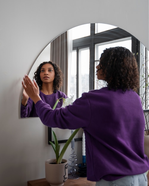 Interior designer arranging mirror in home