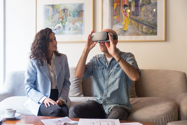 Interior designer talking to customer in VR headset