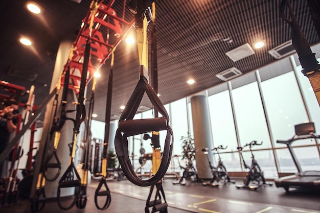 Free Photo interior and equipment in the modern gym, close-up view of suspension straps. sport, fitness, health.