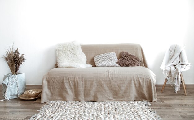 The interior of the living room with a sofa and decorative items.