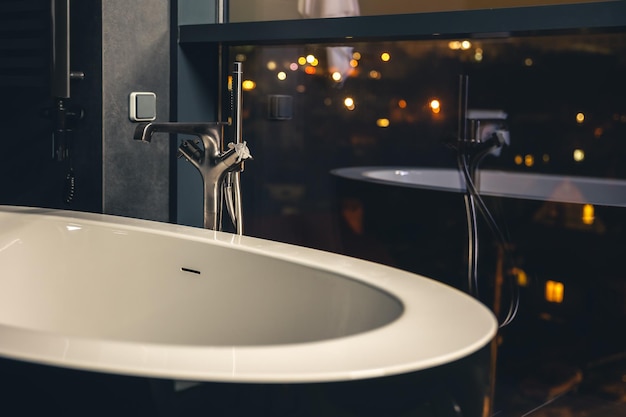 Free photo interior of a modern bathroom with a window overlooking the city