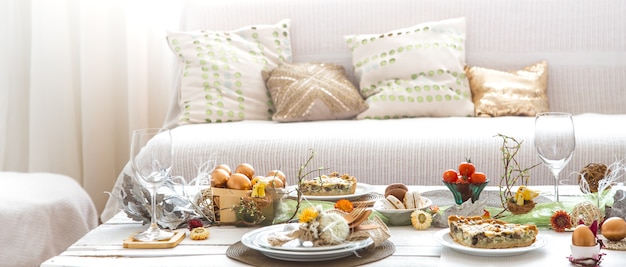 The interior of the room with a festive Easter table .