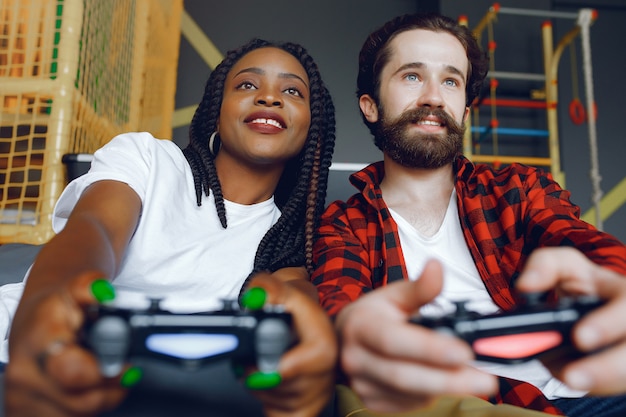 International couple playing a video games