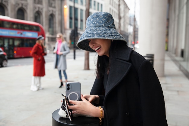 Free photo internet celebrity setting up her smartphone to take a selfie