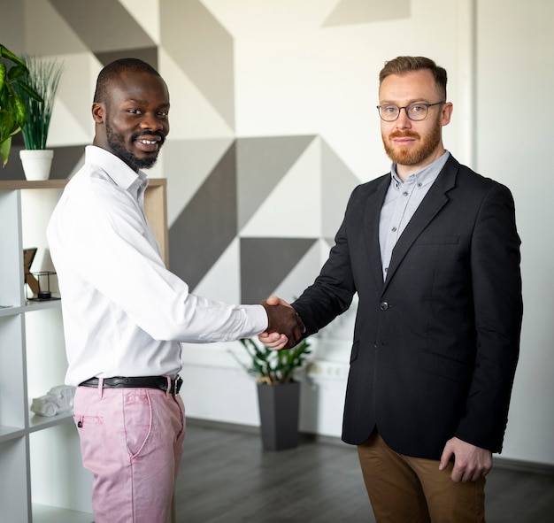 Interracial colleagues shaking hands