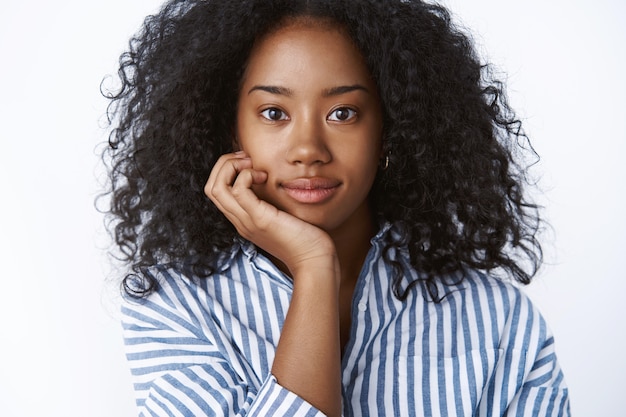 Intersted attractive young curly-haired african american female university student attend interesting lecture leaning head palm looking intrigued curious listening satisfied smiling, looking happy