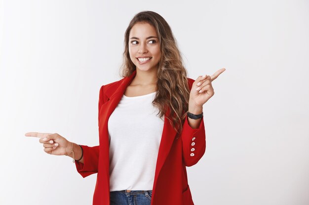 Intrigued enthusiastic good-looking female shopoholic seeing awesome promo smiling excited looking aside pointing different directions thrilled variety choices, looking curious desirable copy space