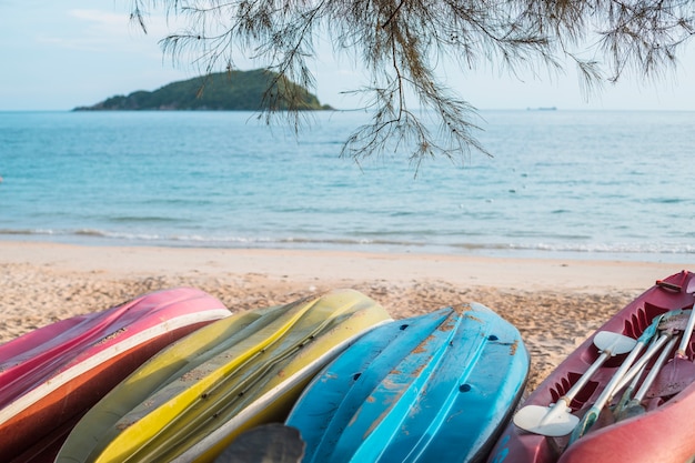 Inverted kayaks on sea shore 