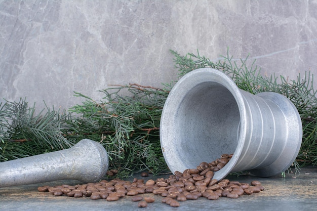 An iron bucket with coffee beans on marble background. High quality photo