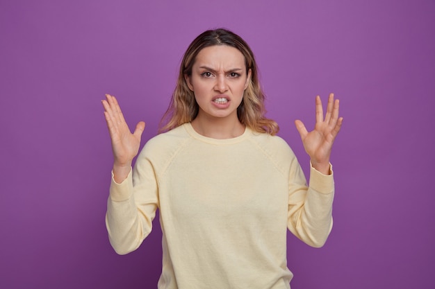 Irritated young girl keeping hands in air 