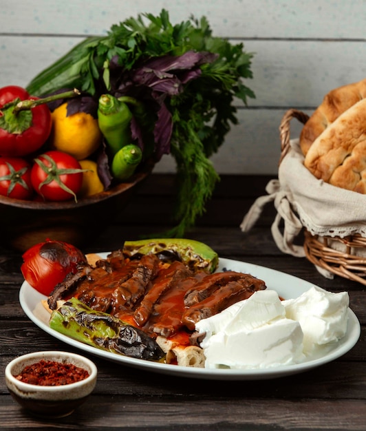 Free photo iskander doner with vegetables on a wooden table