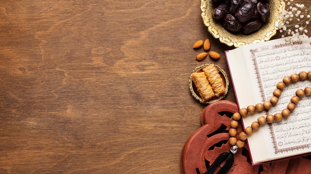 Islamic new year decoration with praying beads on top of open book