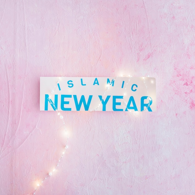 Free photo islamic new year words on paper and garland