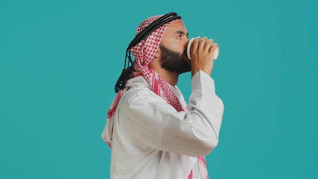 Free photo islamic person drinking cup of coffee