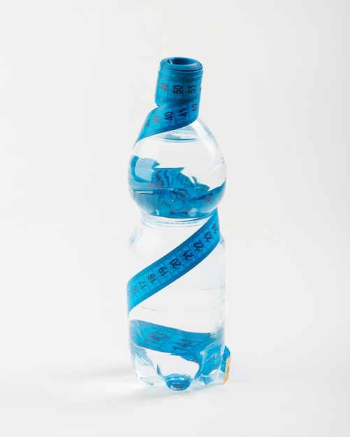 Free photo isolated bottle of water and blue centimetre