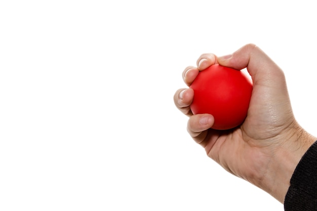 Free photo isolated picture of a person squeezing a red ball