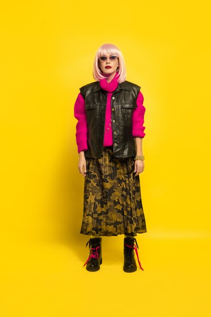 It's hard to be influencer. Stylish look in bright clothes. Caucasian woman's portrait on yellow background. Beautiful blonde model. Concept of human emotions, facial expression, sales, ad.