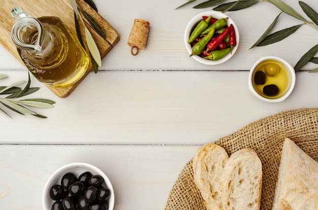 Free photo italian ciabatta bread with olive oil on wooden background