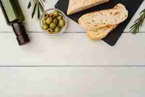 Free photo italian ciabatta bread with olive oil on wooden background