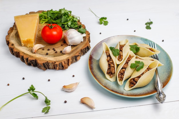 Italian pasta Conchiglioni Rigati stuffed with meat.