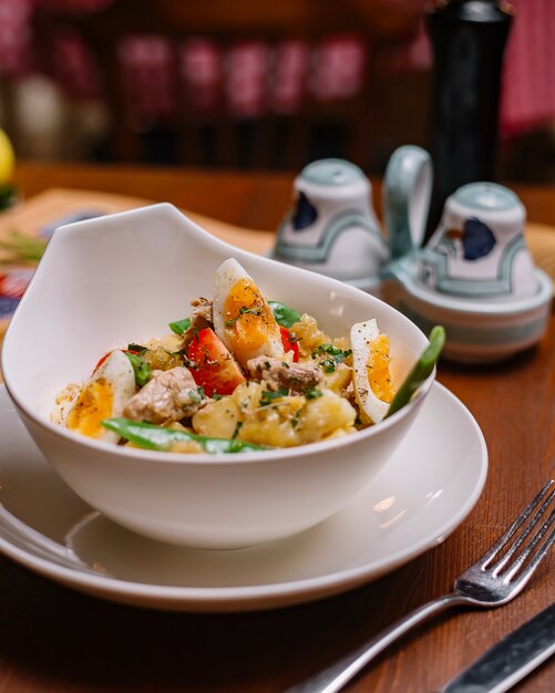 Italian potato salad bowl with tuna beans cherry tomato parsley boiled eggs and olive oil