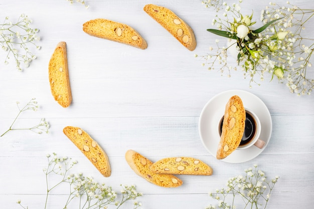 Italian tuscan traditional cookies cantuccini with almonds, a cup of coffee on light