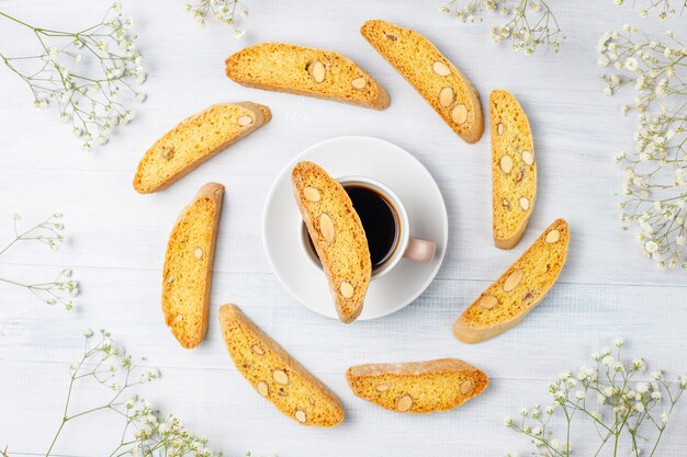 Italian tuscan traditional cookies cantuccini with almonds, a cup of coffee on light