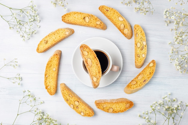 Italian tuscan traditional cookies cantuccini with almonds, a cup of coffee on light