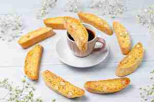 Free photo italian tuscan traditional cookies cantuccini with almonds, a cup of coffee on light