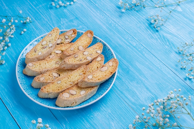 Free photo italian tuscan traditional cookies cantuccini with almonds, a cup of coffee on light