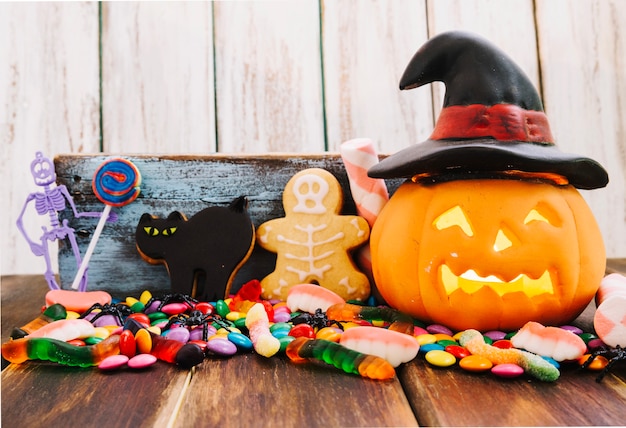 Jack-o-lantern in witch hat and Halloween sweets