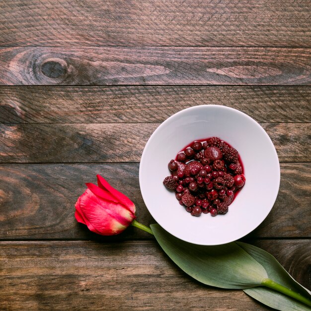 Jam in bowl and fresh flower