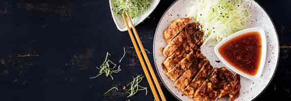 Free photo japanese chop with cabbage and tonkatsu sauce. .