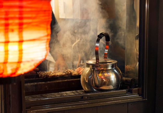 Free photo japanese food court with teapot heating up